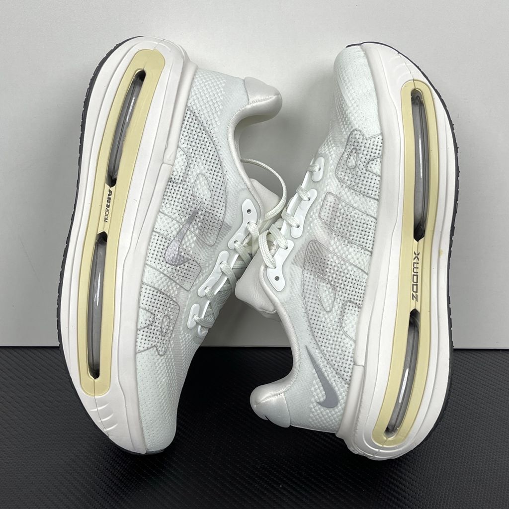 Side profile of the Nike Vomero Premium sneaker in the clean 'Chalk' colorway, showcasing the heavily layered breathable mesh upper, tonal off-white synthetic overlays, the iconic plastic midfoot cage, and the sculpted Cushlon midsole.