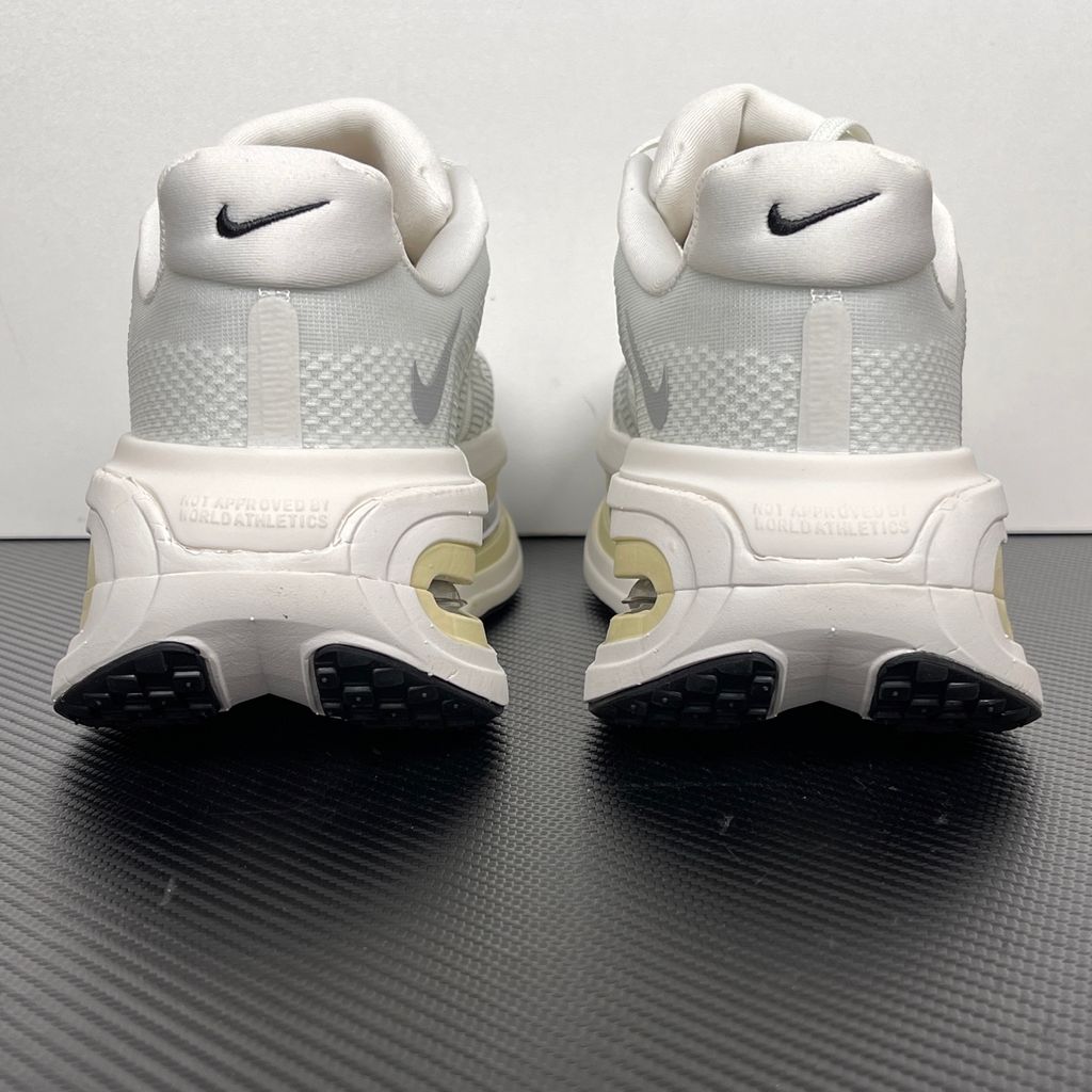 Side profile of the Nike Vomero Premium sneaker in the clean 'Chalk' colorway, showcasing the heavily layered breathable mesh upper, tonal off-white synthetic overlays, the iconic plastic midfoot cage, and the sculpted Cushlon midsole.