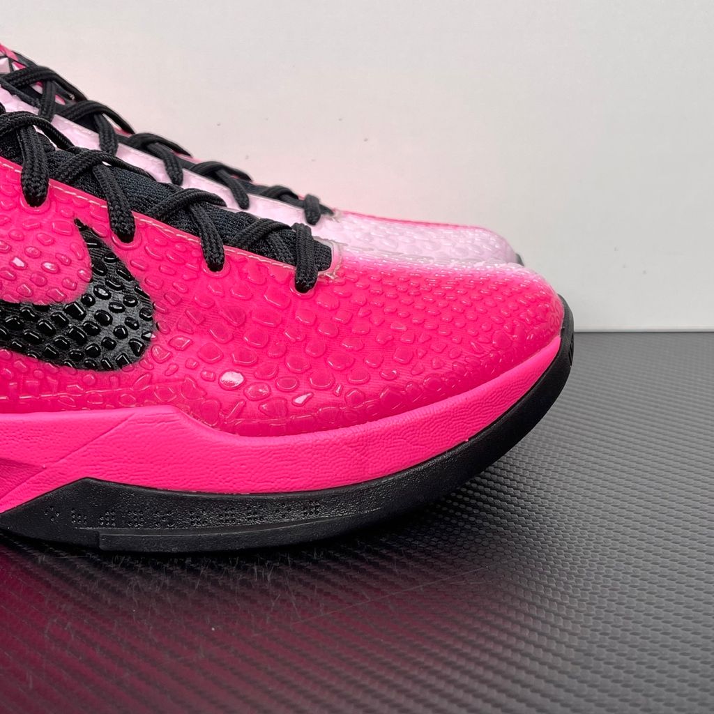 Side profile of the Nike Kobe 6 Protro 'Kay Yow Think Pink' 2026 sneaker, showcasing the vibrant pink snake-scale textured upper, contrasting white Swoosh, signature Kay Yow ribbon detailing on the heel, and the supportive heel counter.