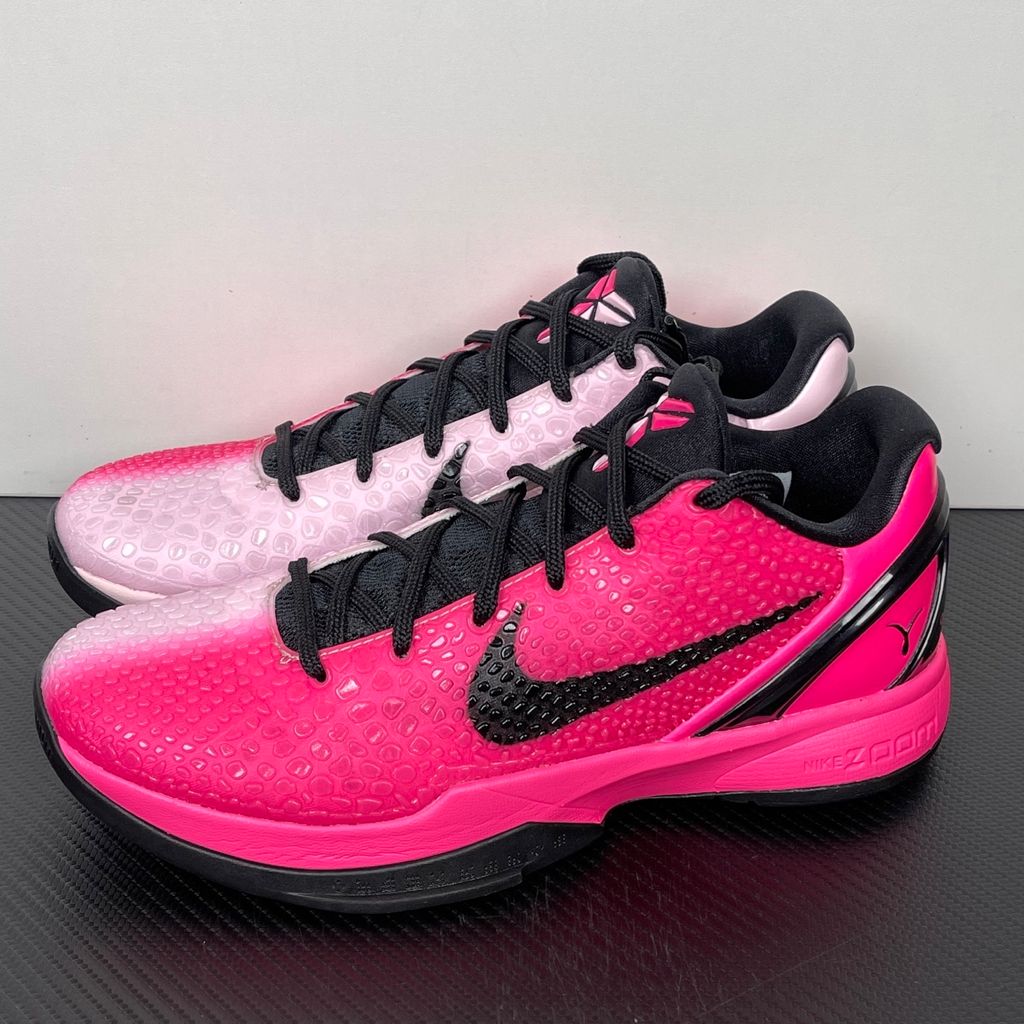 Side profile of the Nike Kobe 6 Protro 'Kay Yow Think Pink' 2026 sneaker, showcasing the vibrant pink snake-scale textured upper, contrasting white Swoosh, signature Kay Yow ribbon detailing on the heel, and the supportive heel counter.