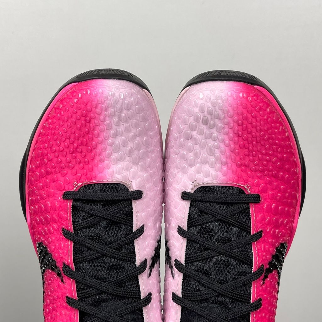 Side profile of the Nike Kobe 6 Protro 'Kay Yow Think Pink' 2026 sneaker, showcasing the vibrant pink snake-scale textured upper, contrasting white Swoosh, signature Kay Yow ribbon detailing on the heel, and the supportive heel counter.