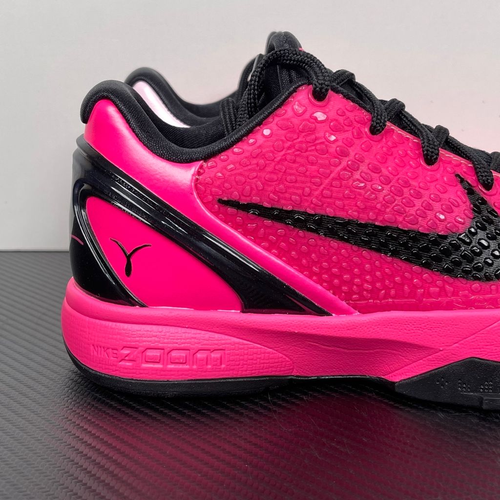 Side profile of the Nike Kobe 6 Protro 'Kay Yow Think Pink' 2026 sneaker, showcasing the vibrant pink snake-scale textured upper, contrasting white Swoosh, signature Kay Yow ribbon detailing on the heel, and the supportive heel counter.