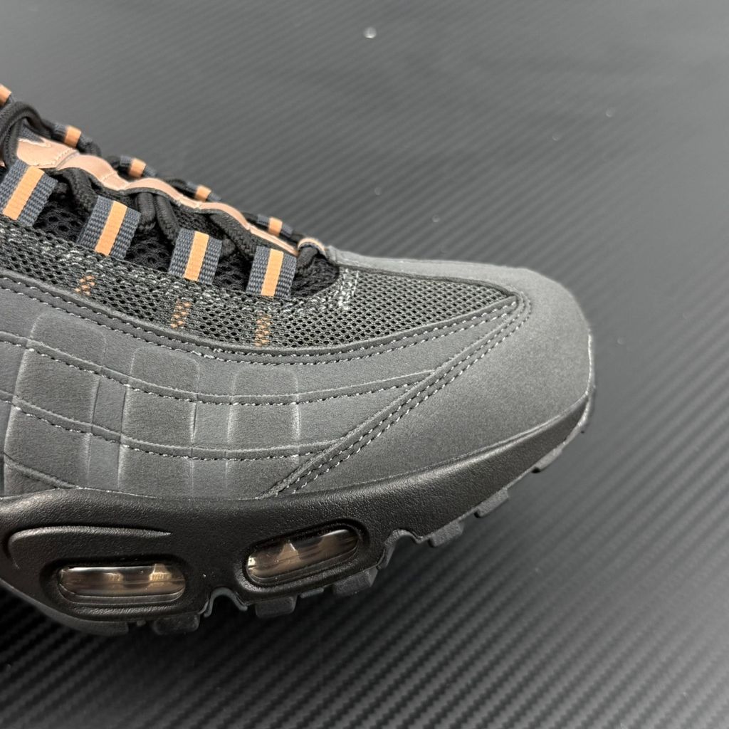 Side profile of the Nike Air Max 95 Central Cee 'Live Yours' sneaker, showcasing the UK drill-inspired dark and metallic layered upper, reflective 3M detailing, exclusive branding, and the signature visible Max Air cushioning units in the black midsole.