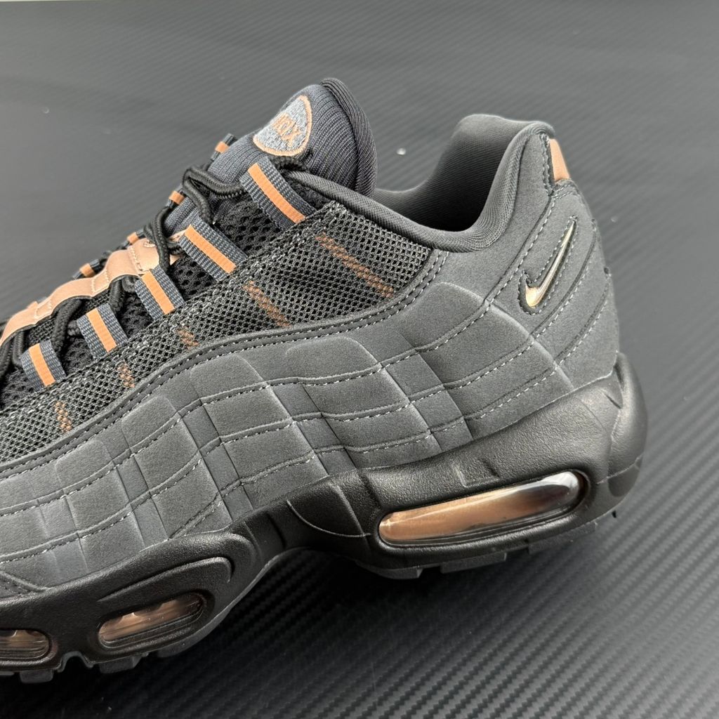 Side profile of the Nike Air Max 95 Central Cee 'Live Yours' sneaker, showcasing the UK drill-inspired dark and metallic layered upper, reflective 3M detailing, exclusive branding, and the signature visible Max Air cushioning units in the black midsole.