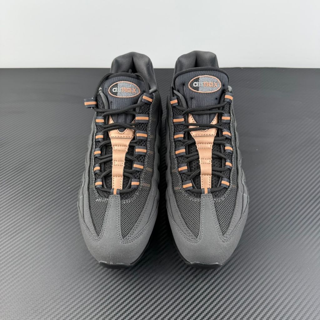 Side profile of the Nike Air Max 95 Central Cee 'Live Yours' sneaker, showcasing the UK drill-inspired dark and metallic layered upper, reflective 3M detailing, exclusive branding, and the signature visible Max Air cushioning units in the black midsole.