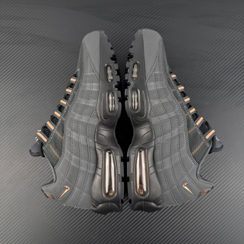 Side profile of the Nike Air Max 95 Central Cee 'Live Yours' sneaker, showcasing the UK drill-inspired dark and metallic layered upper, reflective 3M detailing, exclusive branding, and the signature visible Max Air cushioning units in the black midsole.