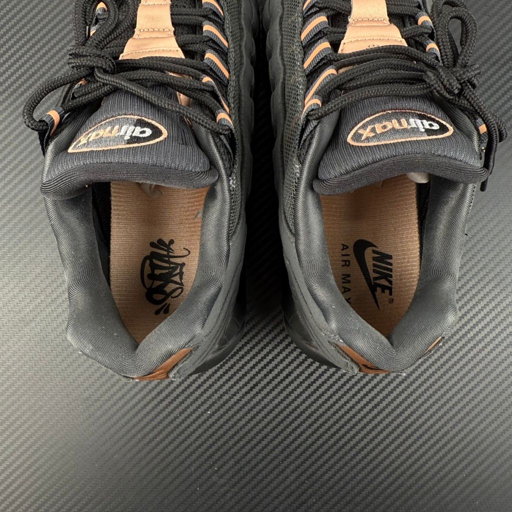 Side profile of the Nike Air Max 95 Central Cee 'Live Yours' sneaker, showcasing the UK drill-inspired dark and metallic layered upper, reflective 3M detailing, exclusive branding, and the signature visible Max Air cushioning units in the black midsole.