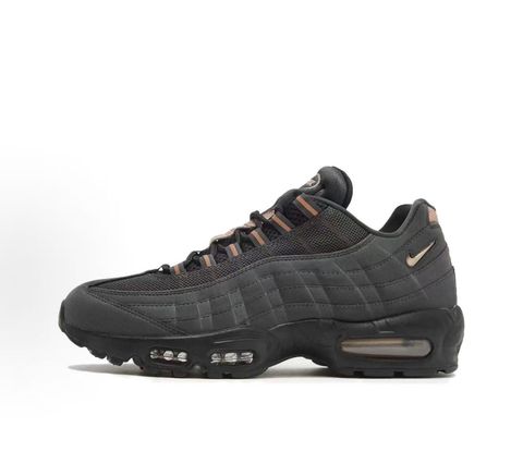 Side profile of the Nike Air Max 95 Central Cee 'Live Yours' sneaker, showcasing the UK drill-inspired dark and metallic layered upper, reflective 3M detailing, exclusive branding, and the signature visible Max Air cushioning units in the black midsole.