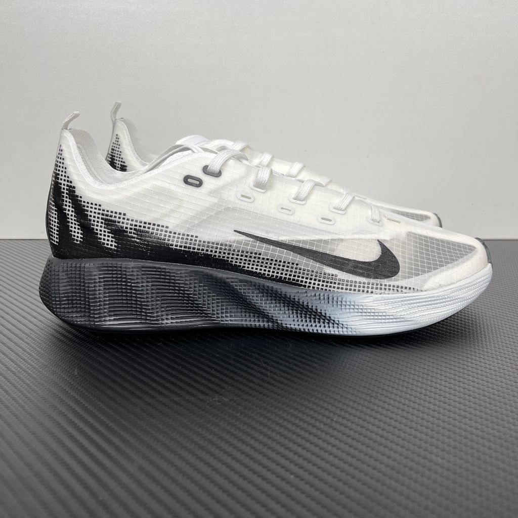 Side profile of the Nike Ava X sneaker in the crisp 'Summit White Black' colorway, showcasing a breathable white mesh upper, sharp contrasting black Swoosh and synthetic overlays, and a sculpted, responsive foam midsole.
