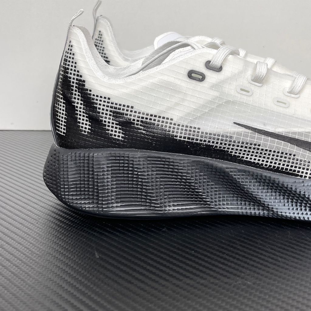 Side profile of the Nike Ava X sneaker in the crisp 'Summit White Black' colorway, showcasing a breathable white mesh upper, sharp contrasting black Swoosh and synthetic overlays, and a sculpted, responsive foam midsole.