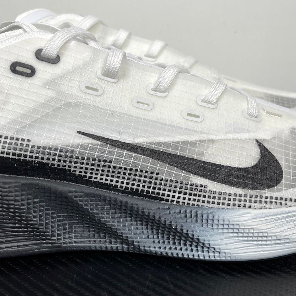 Side profile of the Nike Ava X sneaker in the crisp 'Summit White Black' colorway, showcasing a breathable white mesh upper, sharp contrasting black Swoosh and synthetic overlays, and a sculpted, responsive foam midsole.