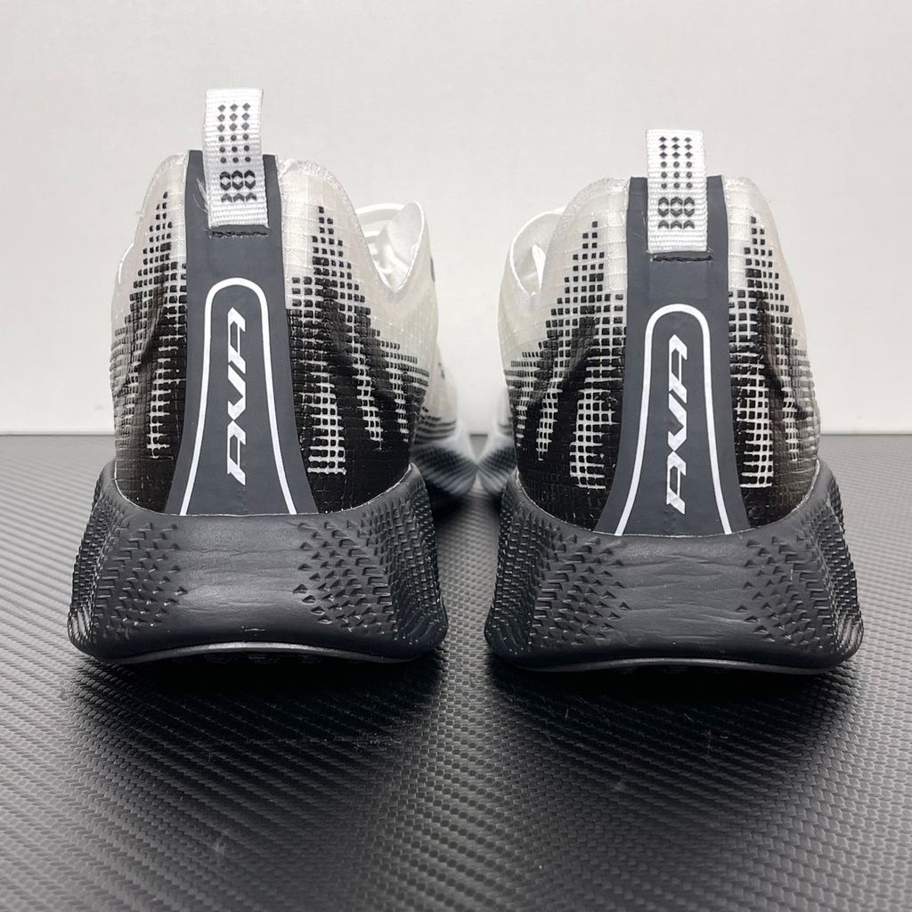 Side profile of the Nike Ava X sneaker in the crisp 'Summit White Black' colorway, showcasing a breathable white mesh upper, sharp contrasting black Swoosh and synthetic overlays, and a sculpted, responsive foam midsole.