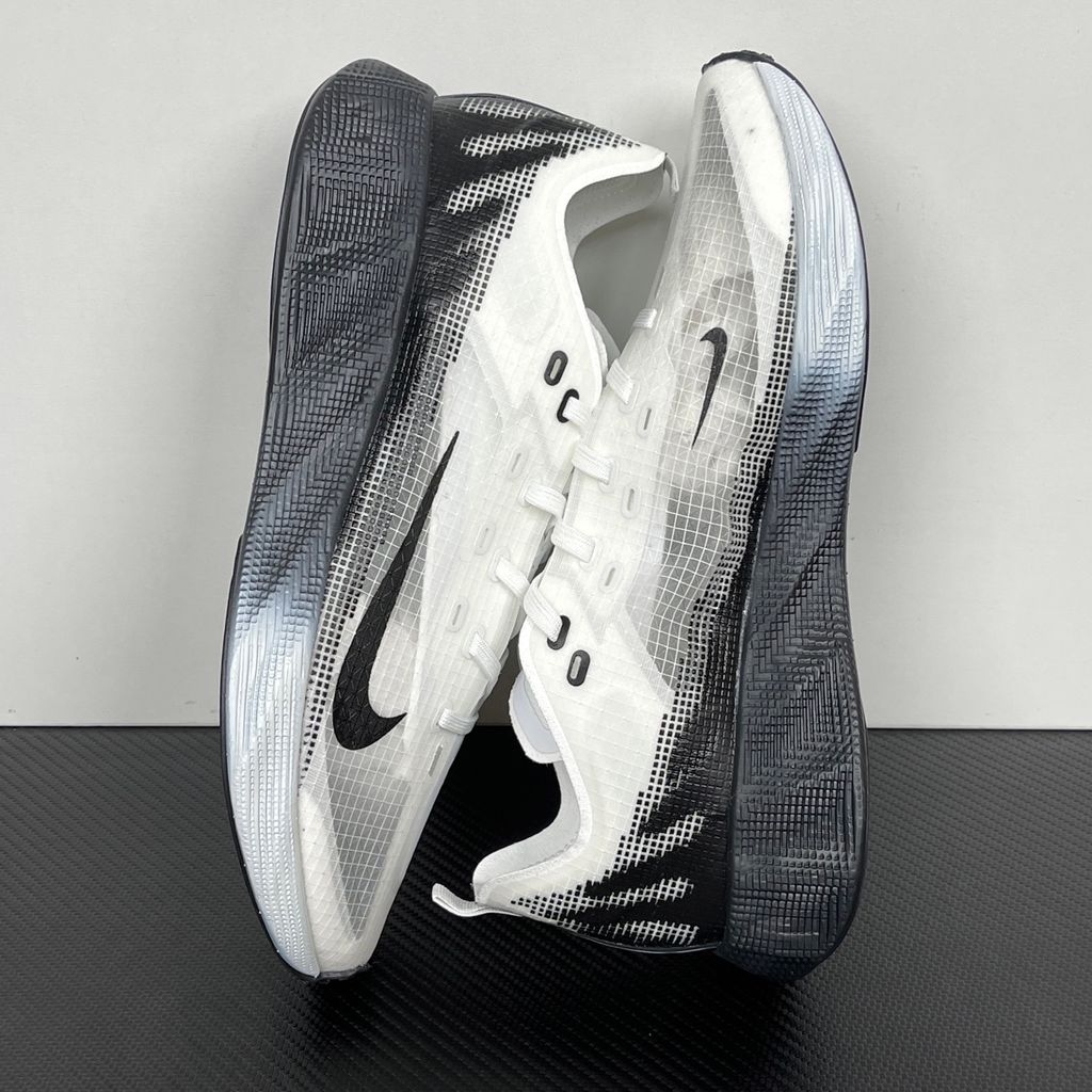 Side profile of the Nike Ava X sneaker in the crisp 'Summit White Black' colorway, showcasing a breathable white mesh upper, sharp contrasting black Swoosh and synthetic overlays, and a sculpted, responsive foam midsole.