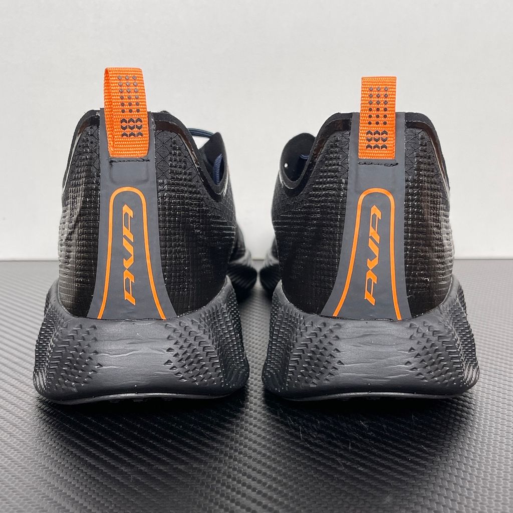 Side profile of the Nike Ava X sneaker in the 'Dark Obsidian Bright Mandarin' colorway, showcasing a deep navy blue breathable mesh upper, vibrant orange contrasting Swoosh and synthetic overlays, and a sculpted, responsive foam midsole.