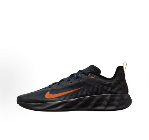 Side profile of the Nike Ava X sneaker in the 'Dark Obsidian Bright Mandarin' colorway, showcasing a deep navy blue breathable mesh upper, vibrant orange contrasting Swoosh and synthetic overlays, and a sculpted, responsive foam midsole.