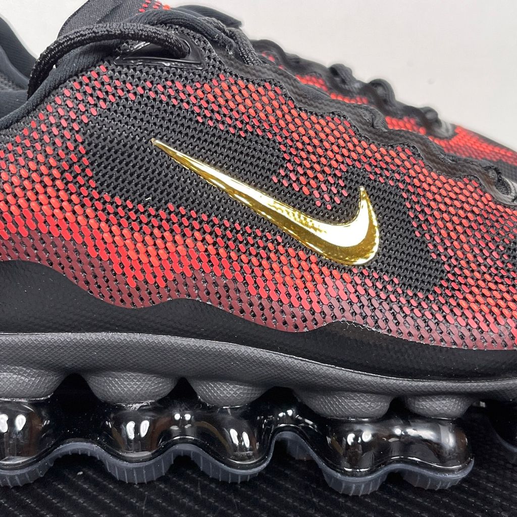 Side profile of the Nike Air Liquid Max sneaker in the 'Bright Crimson Fire Red' colorway, showcasing a fluid, aerodynamic mesh upper with vibrant red and crimson synthetic overlays, and a prominent visible Max Air cushioning unit in the heel and midfoot.