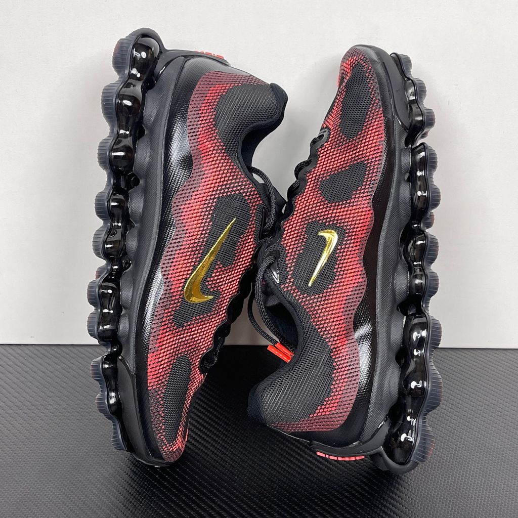 Side profile of the Nike Air Liquid Max sneaker in the 'Bright Crimson Fire Red' colorway, showcasing a fluid, aerodynamic mesh upper with vibrant red and crimson synthetic overlays, and a prominent visible Max Air cushioning unit in the heel and midfoot.