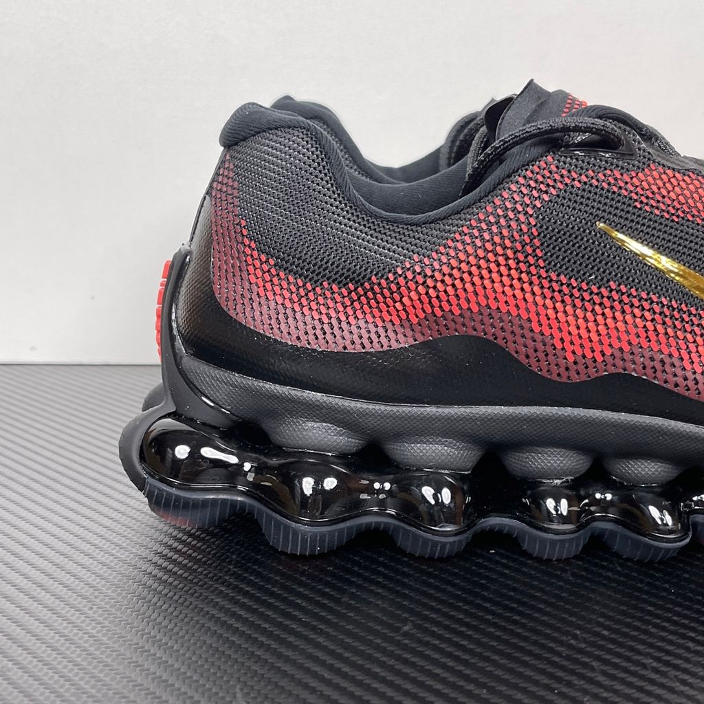 Side profile of the Nike Air Liquid Max sneaker in the 'Bright Crimson Fire Red' colorway, showcasing a fluid, aerodynamic mesh upper with vibrant red and crimson synthetic overlays, and a prominent visible Max Air cushioning unit in the heel and midfoot.
