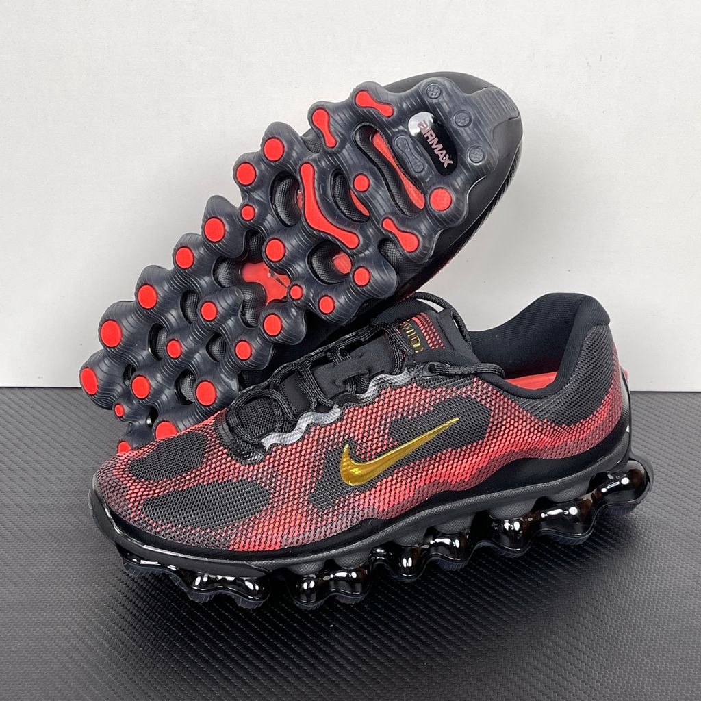 Side profile of the Nike Air Liquid Max sneaker in the 'Bright Crimson Fire Red' colorway, showcasing a fluid, aerodynamic mesh upper with vibrant red and crimson synthetic overlays, and a prominent visible Max Air cushioning unit in the heel and midfoot.