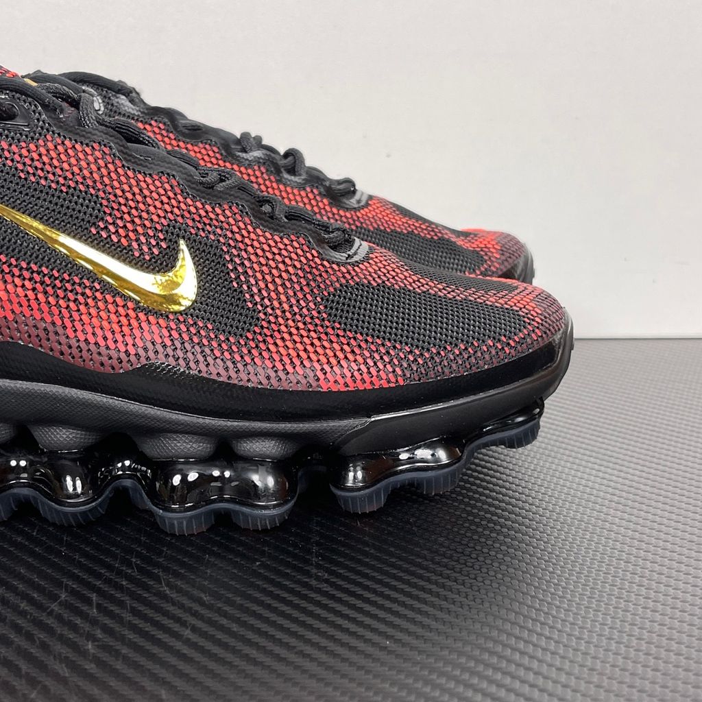 Side profile of the Nike Air Liquid Max sneaker in the 'Bright Crimson Fire Red' colorway, showcasing a fluid, aerodynamic mesh upper with vibrant red and crimson synthetic overlays, and a prominent visible Max Air cushioning unit in the heel and midfoot.
