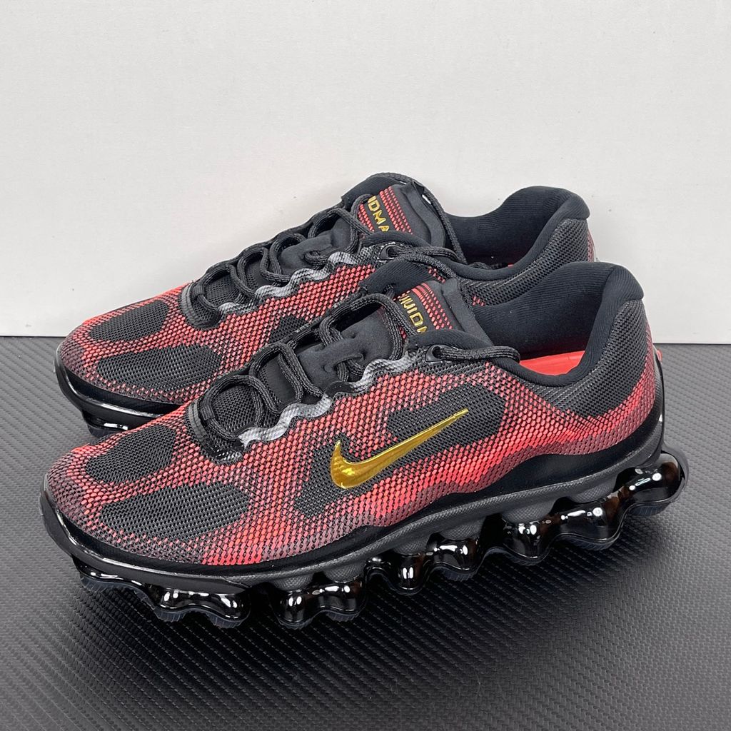 Side profile of the Nike Air Liquid Max sneaker in the 'Bright Crimson Fire Red' colorway, showcasing a fluid, aerodynamic mesh upper with vibrant red and crimson synthetic overlays, and a prominent visible Max Air cushioning unit in the heel and midfoot.