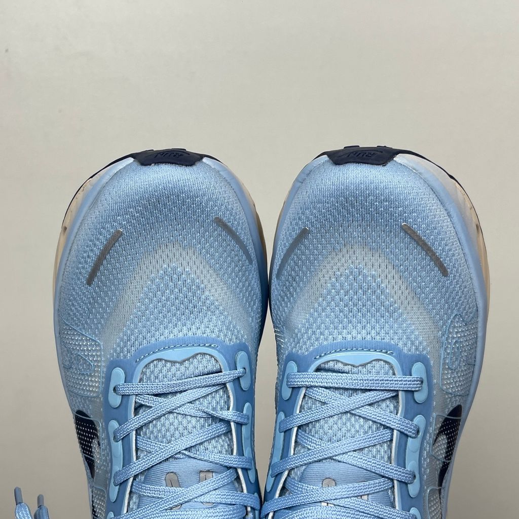 Side profile of the Nike Vomero Premium sneaker in the 'Aluminum' colorway, showcasing the heavily layered breathable mesh upper, cool-toned metallic synthetic overlays, the iconic plastic midfoot cage, and the sculpted Cushlon midsole.