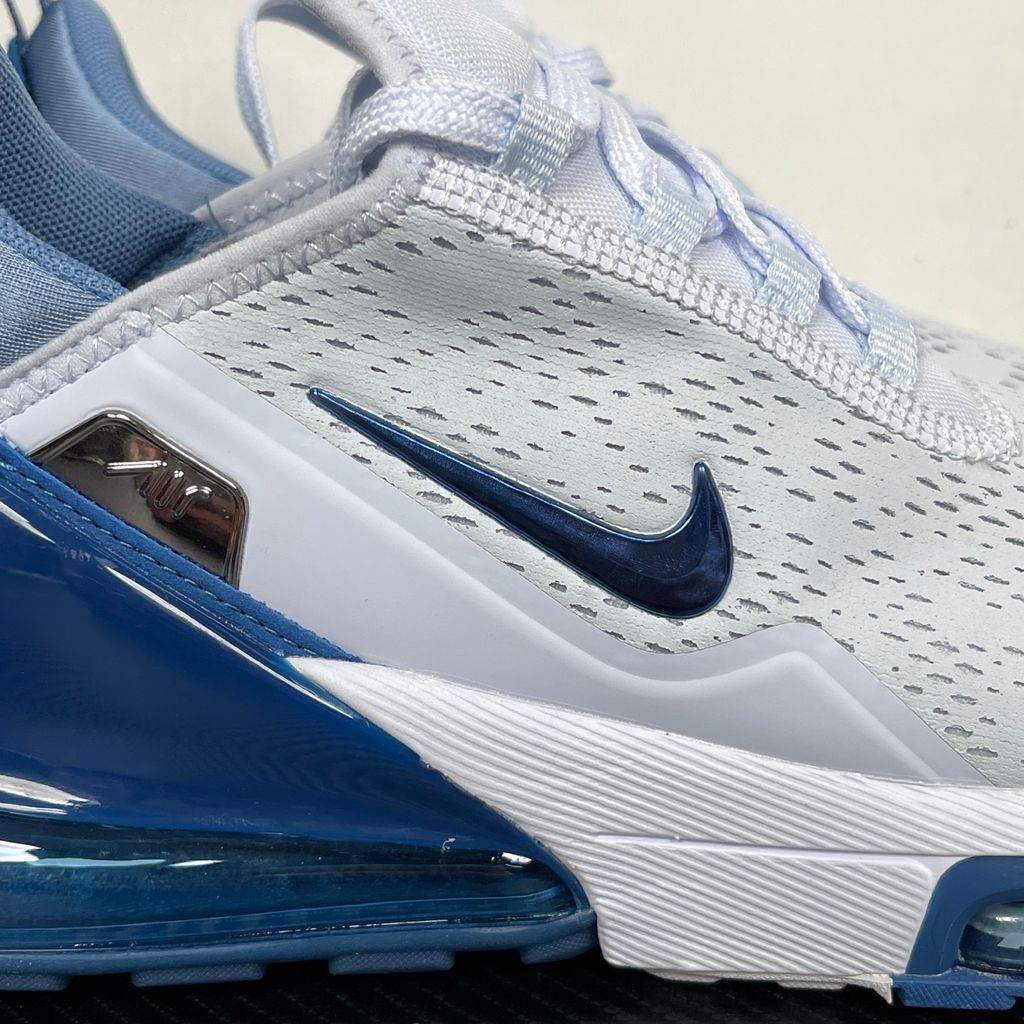 Side profile of the Nike Air Max 270 Premium sneaker in a subtle 'Football Grey' and 'Work Blue' colorway, highlighting the updated breathable premium upper, tonal overlays, and the massive, signature translucent 270-degree Max Air heel unit.