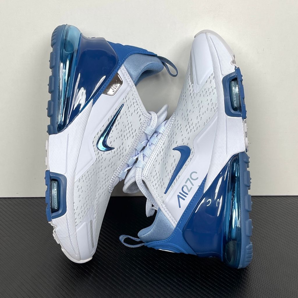 Side profile of the Nike Air Max 270 Premium sneaker in a subtle 'Football Grey' and 'Work Blue' colorway, highlighting the updated breathable premium upper, tonal overlays, and the massive, signature translucent 270-degree Max Air heel unit.