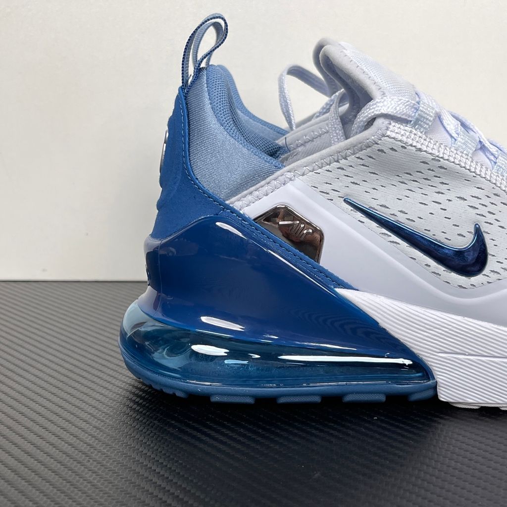 Side profile of the Nike Air Max 270 Premium sneaker in a subtle 'Football Grey' and 'Work Blue' colorway, highlighting the updated breathable premium upper, tonal overlays, and the massive, signature translucent 270-degree Max Air heel unit.