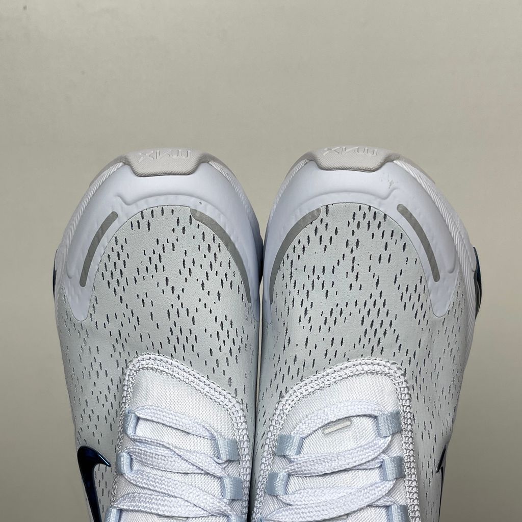 Side profile of the Nike Air Max 270 Premium sneaker in a subtle 'Football Grey' and 'Work Blue' colorway, highlighting the updated breathable premium upper, tonal overlays, and the massive, signature translucent 270-degree Max Air heel unit.