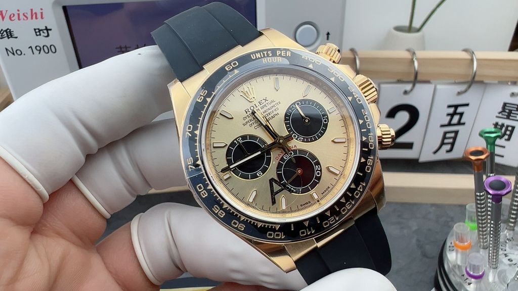 Front-facing view of the Rolex Cosmograph Daytona 126518LN, highlighting the polished 18ct yellow gold case, contrasting black Cerachrom tachymetric bezel, and the sophisticated golden and black dial with snailed counters.