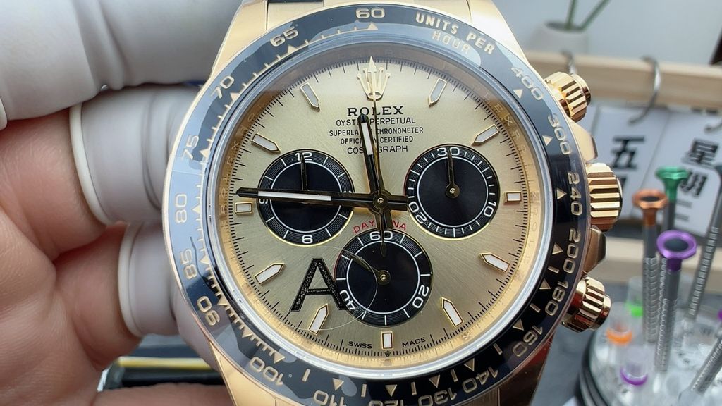 Front-facing view of the Rolex Cosmograph Daytona 126518LN, highlighting the polished 18ct yellow gold case, contrasting black Cerachrom tachymetric bezel, and the sophisticated golden and black dial with snailed counters.