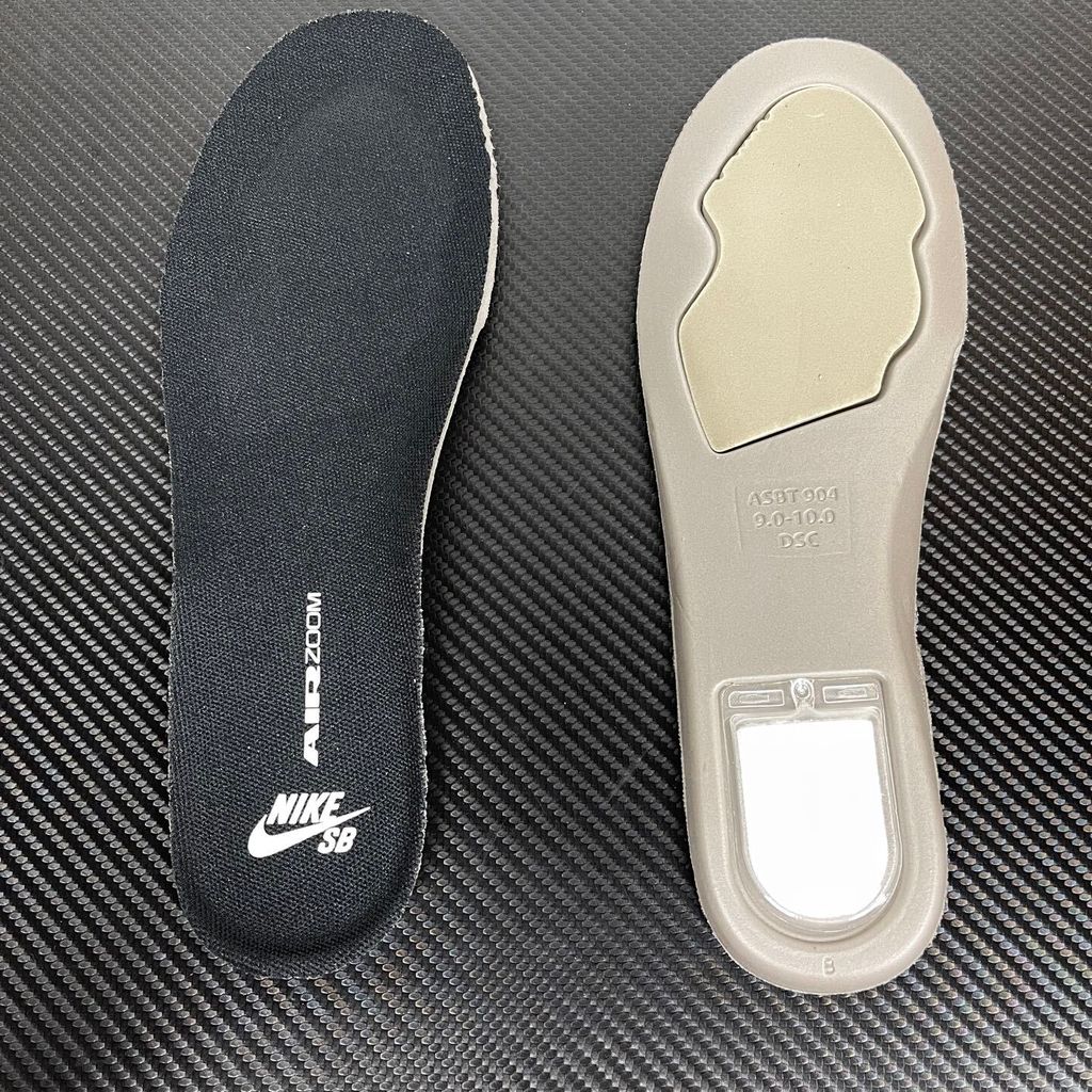 Side profile of the Nike Dunk Low Pro SB 'Black White Gum' sneaker, showcasing the clean black and white leather color blocking, signature padded SB tongue, and the classic gum rubber outsole.