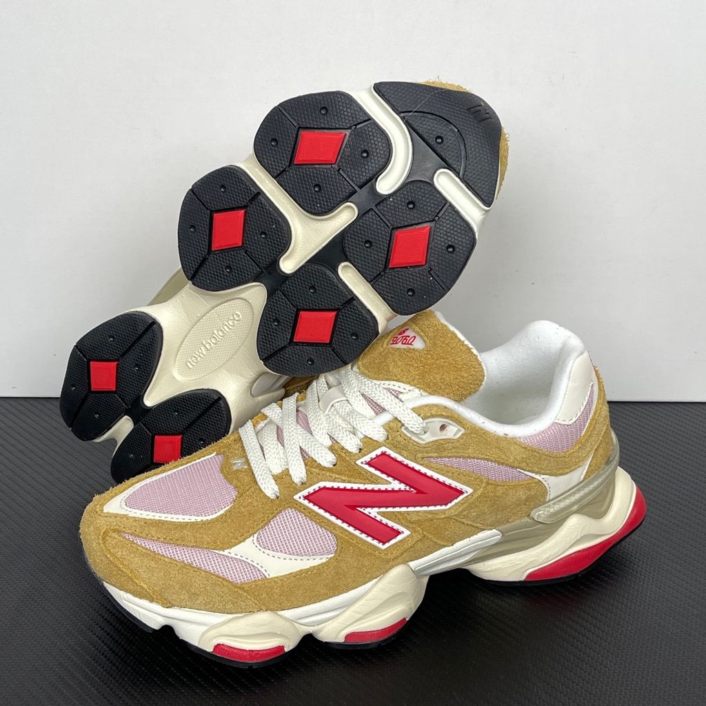 Side profile of the New Balance 9060 sneaker in the striking 'Great Plains True Red' colorway, showcasing the retro-futuristic chunky midsole, highly textured breathable mesh upper with vibrant red suede overlays, and the signature metallic 'N' logo.