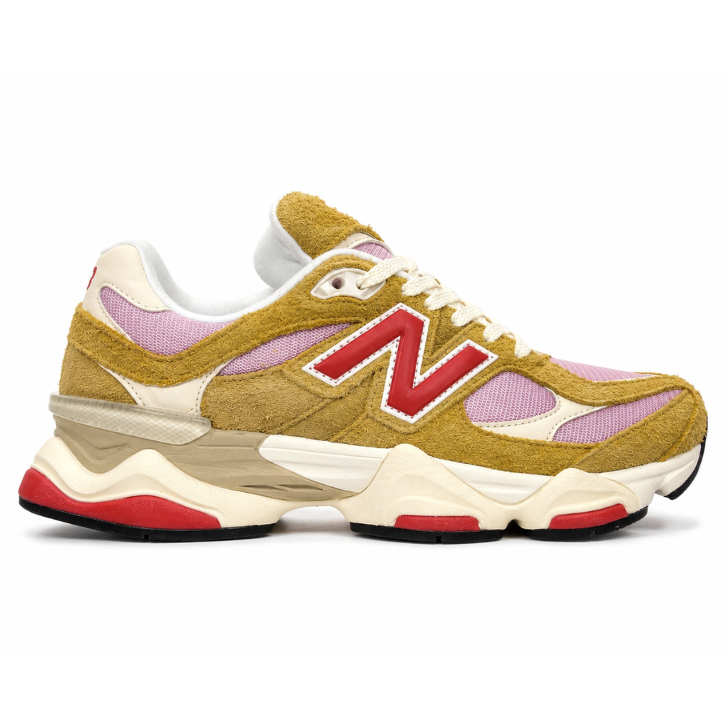 Side profile of the New Balance 9060 sneaker in the striking 'Great Plains True Red' colorway, showcasing the retro-futuristic chunky midsole, highly textured breathable mesh upper with vibrant red suede overlays, and the signature metallic 'N' logo.