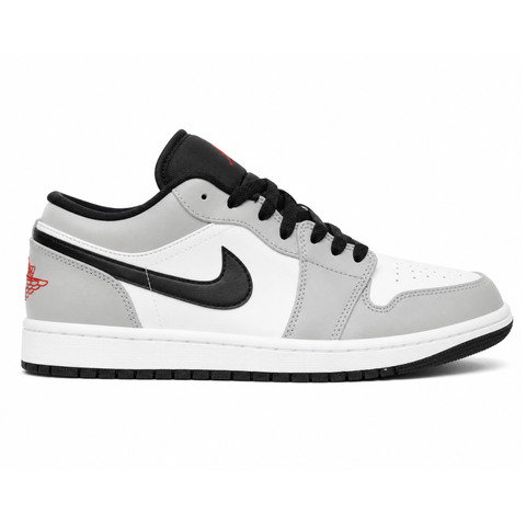 Side profile of the Air Jordan 1 Low 'Light Smoke Grey' sneaker, highlighting the smooth white base, contrasting Light Smoke Grey overlays, black Swoosh branding, and the classic low-top profile.