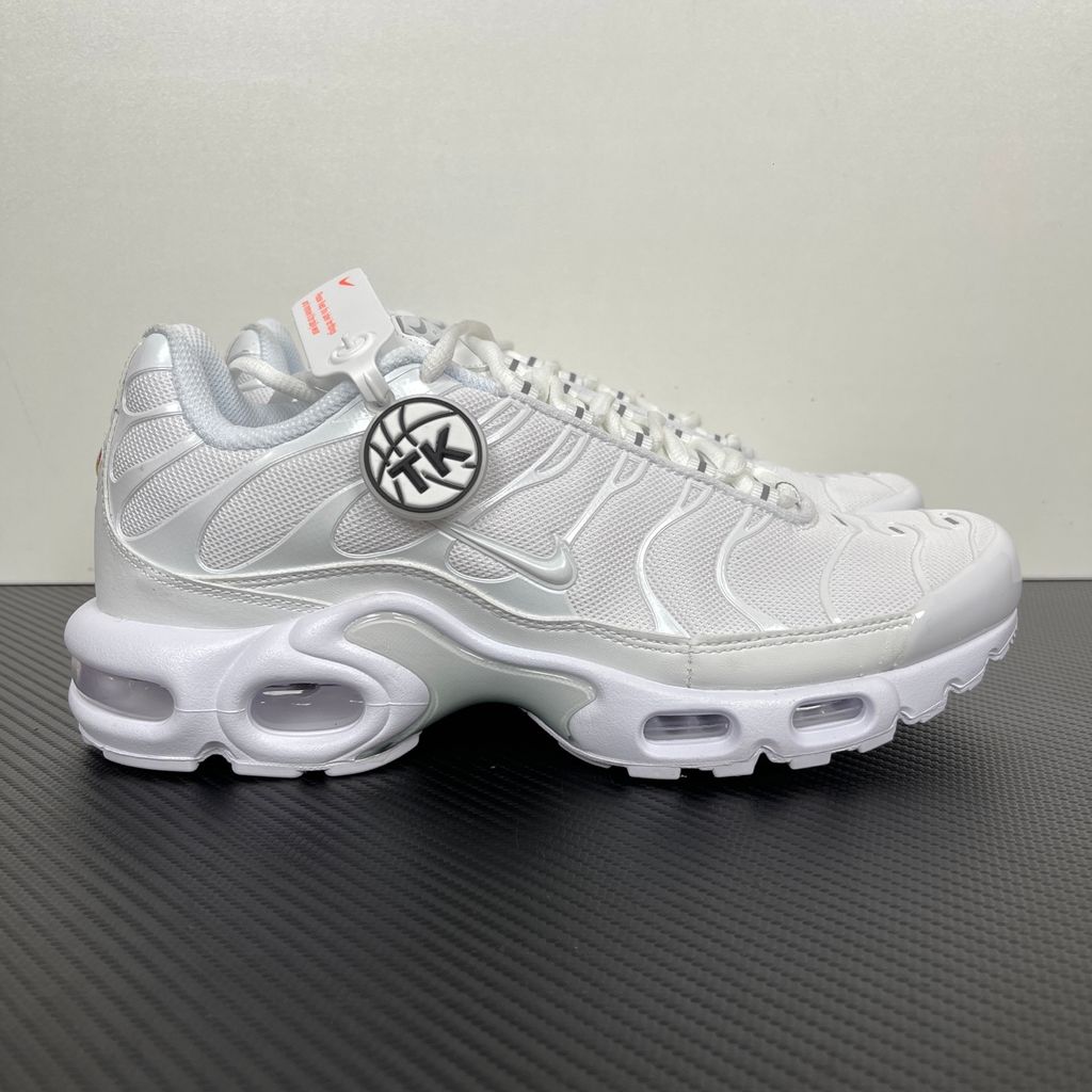 Side profile of the Nike Air Max Plus sneaker in the 'White Pure Platinum' colorway, highlighting the iconic wavy TPU overlays, clean breathable white mesh upper, and the visible Tuned Air cushioning units in the midsole.