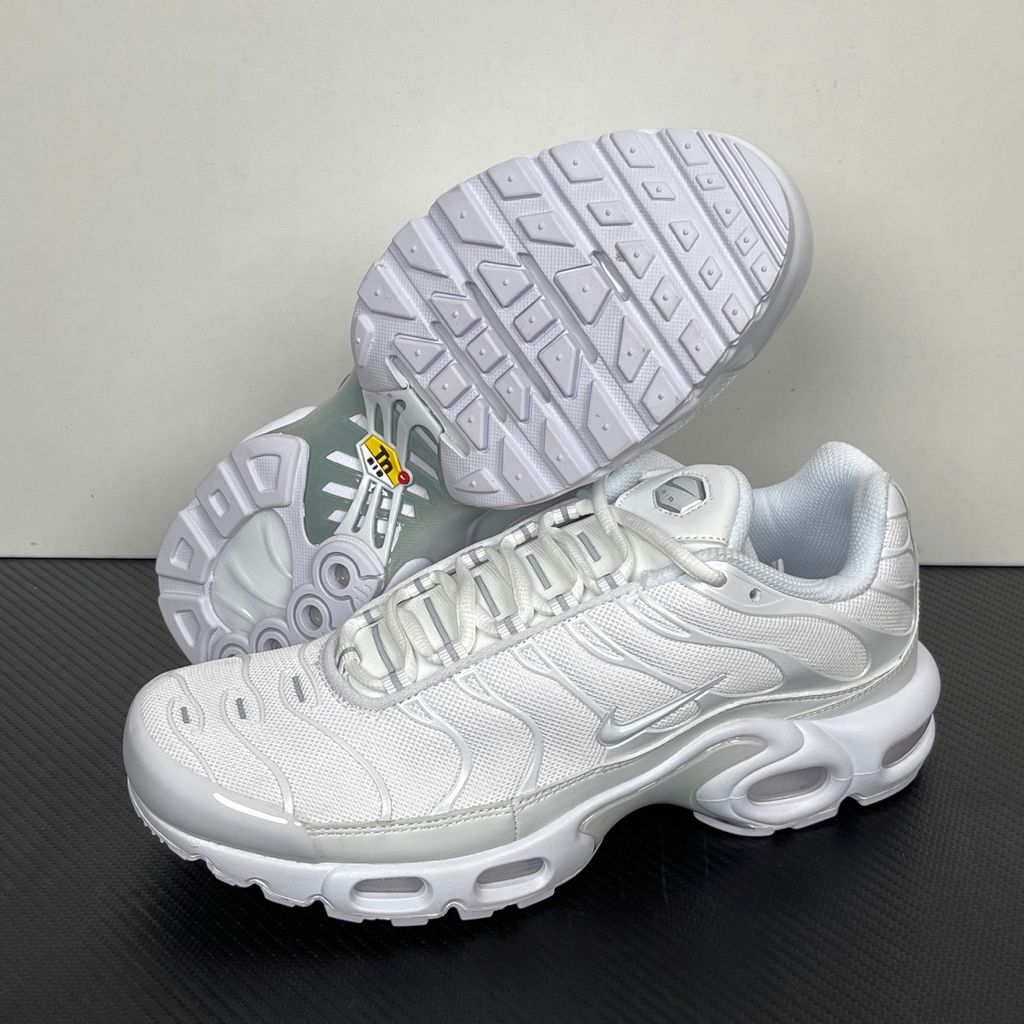 Side profile of the Nike Air Max Plus sneaker in the 'White Pure Platinum' colorway, highlighting the iconic wavy TPU overlays, clean breathable white mesh upper, and the visible Tuned Air cushioning units in the midsole.
