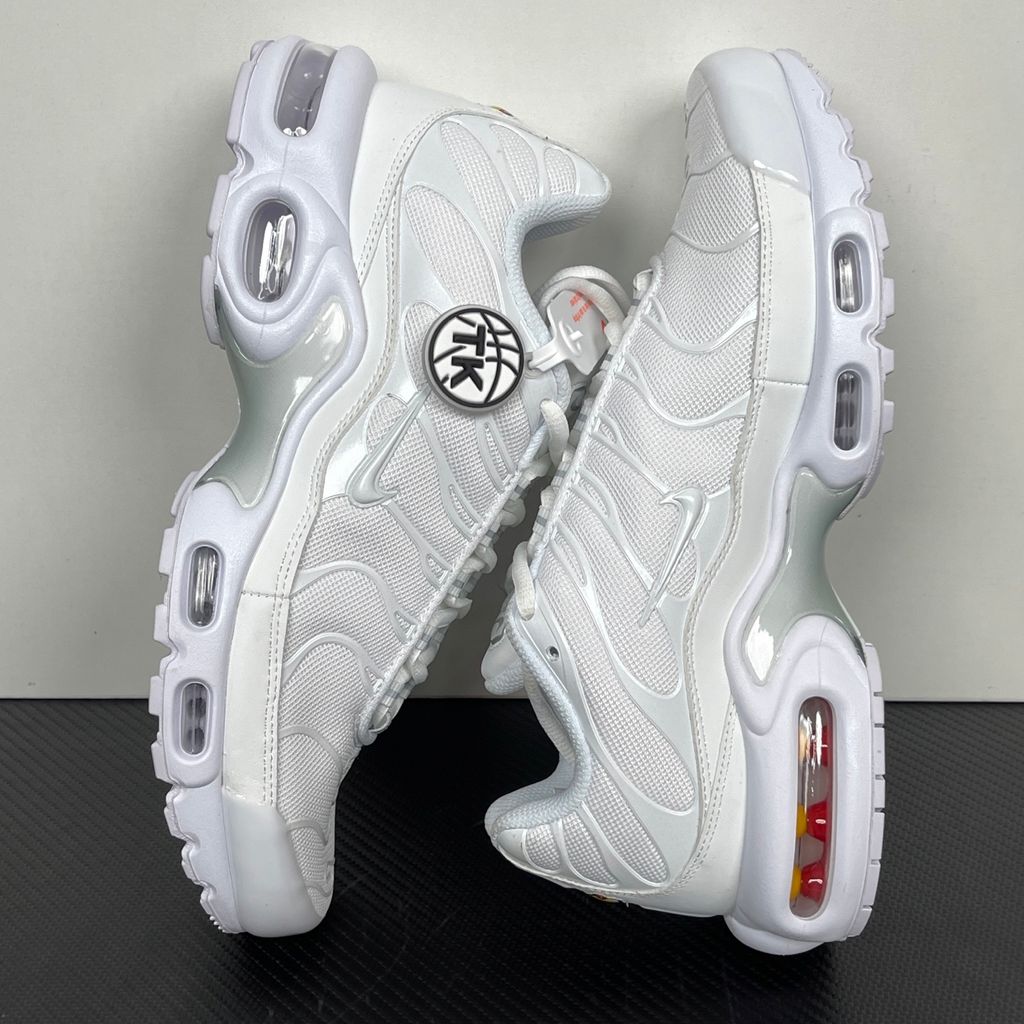 Side profile of the Nike Air Max Plus sneaker in the 'White Pure Platinum' colorway, highlighting the iconic wavy TPU overlays, clean breathable white mesh upper, and the visible Tuned Air cushioning units in the midsole.
