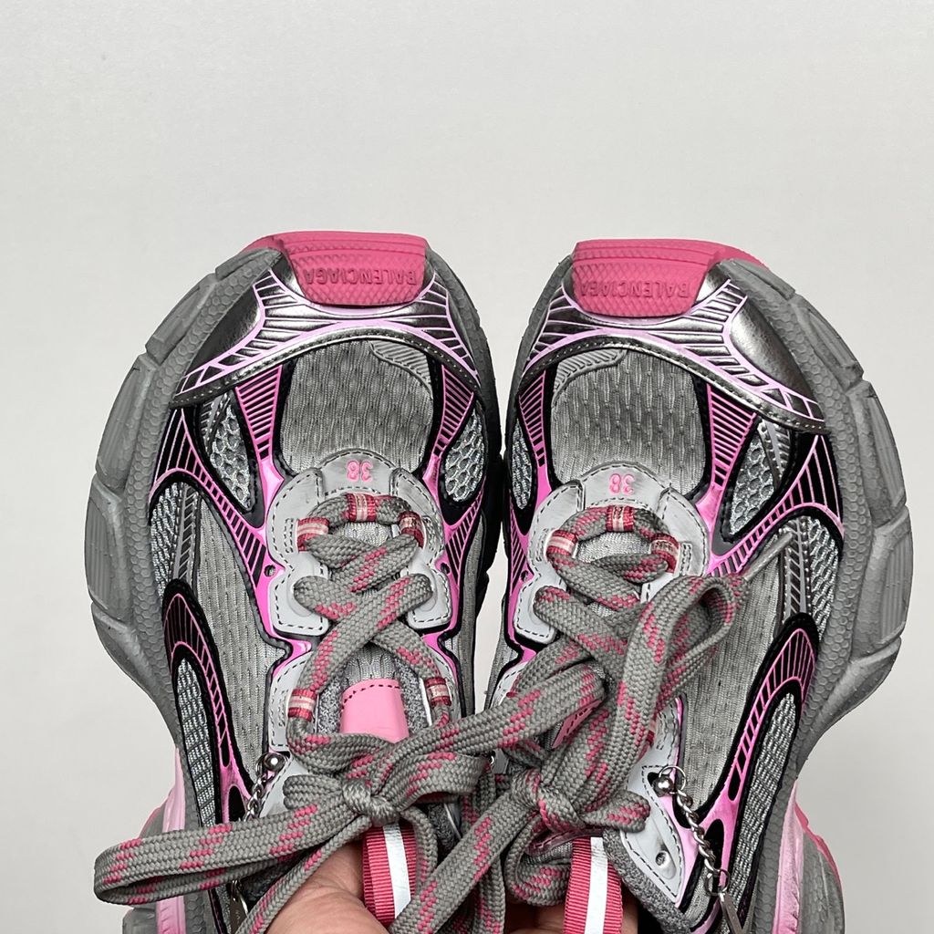 Side profile of the Balenciaga 3XL Gradient sneaker in 'Grey Pink', showcasing the exaggerated chunky midsole, intricate layered mesh and metallic upper, and the signature hanging chain charm hardware.