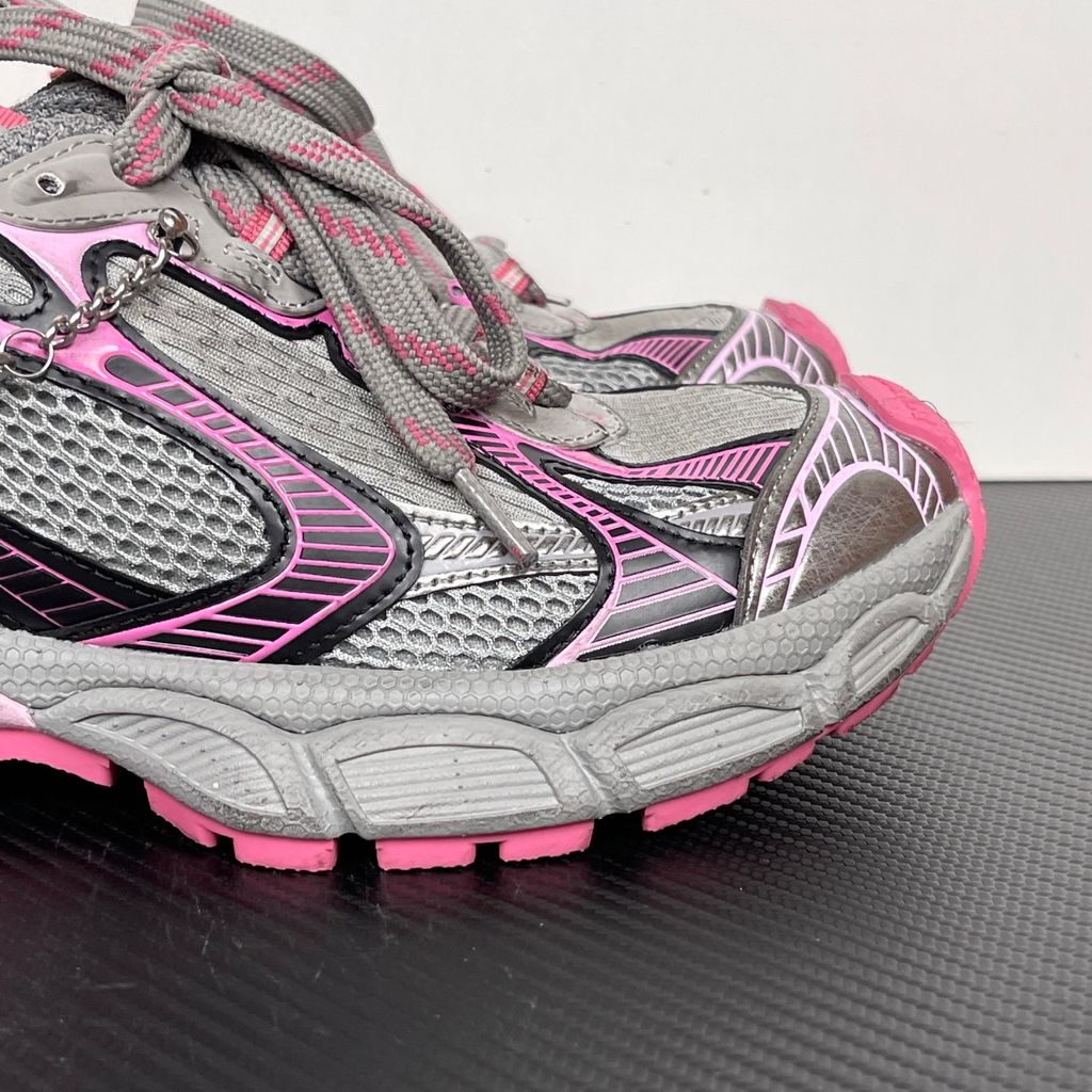 Side profile of the Balenciaga 3XL Gradient sneaker in 'Grey Pink', showcasing the exaggerated chunky midsole, intricate layered mesh and metallic upper, and the signature hanging chain charm hardware.
