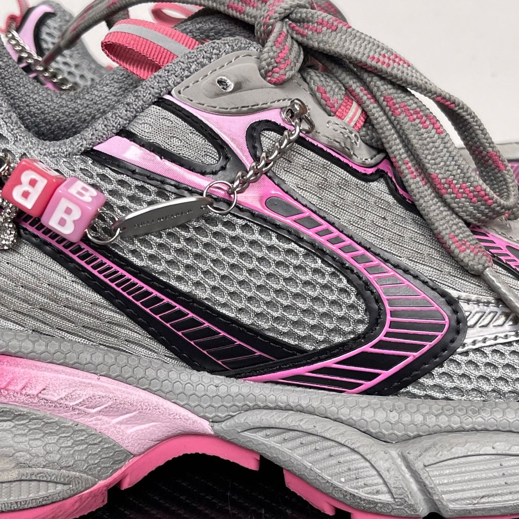 Side profile of the Balenciaga 3XL Gradient sneaker in 'Grey Pink', showcasing the exaggerated chunky midsole, intricate layered mesh and metallic upper, and the signature hanging chain charm hardware.