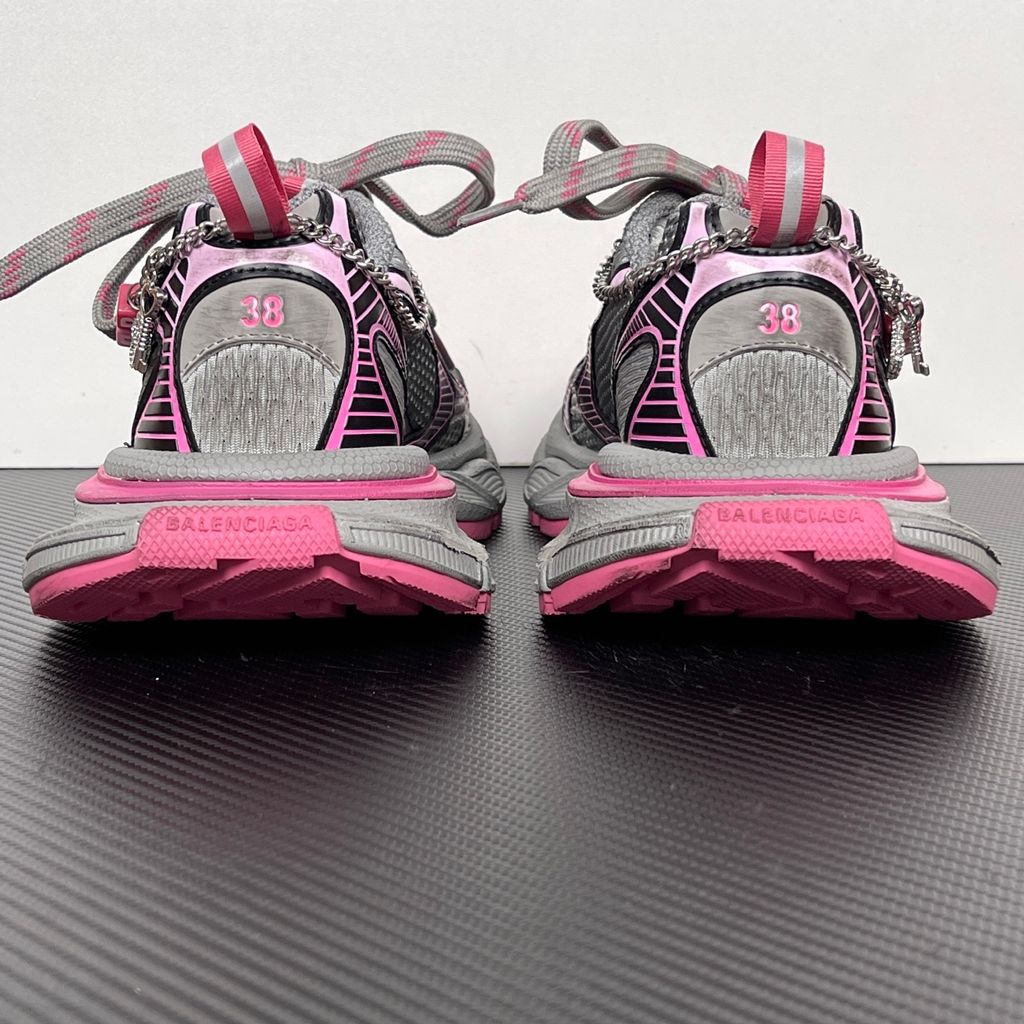 Side profile of the Balenciaga 3XL Gradient sneaker in 'Grey Pink', showcasing the exaggerated chunky midsole, intricate layered mesh and metallic upper, and the signature hanging chain charm hardware.