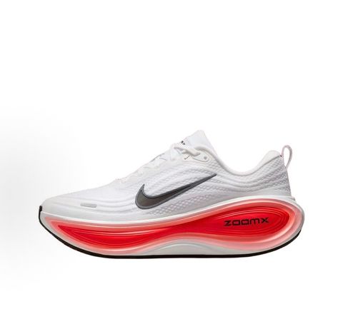 Side profile of the Nike Vomero Plus sneaker in the 'White Black Bright Crimson' colorway, showcasing the clean white mesh base, bold black synthetic overlays, and striking Bright Crimson accents on the midsole and branding.