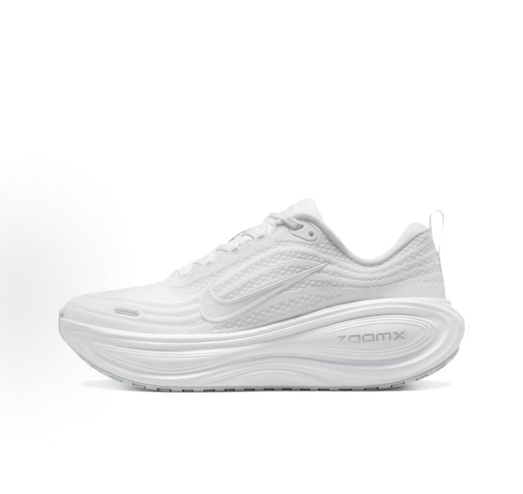 Side profile of the Nike Vomero Plus sneaker in the 'White' colorway, showcasing the clean, monochromatic mesh upper, tonal synthetic overlays, and the sculpted, high-performance foam midsole.