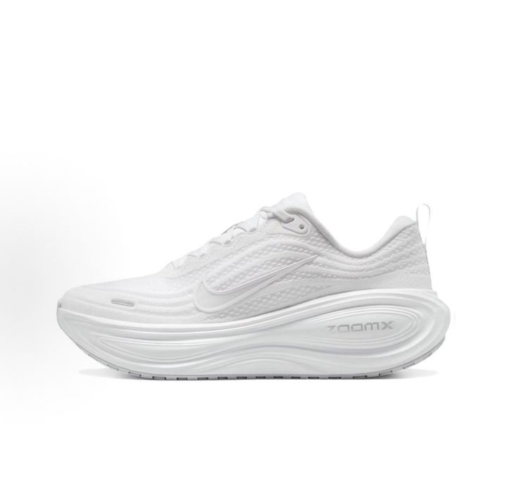 Side profile of the Nike Vomero Plus sneaker in the 'White' colorway, showcasing the clean, monochromatic mesh upper, tonal synthetic overlays, and the sculpted, high-performance foam midsole.