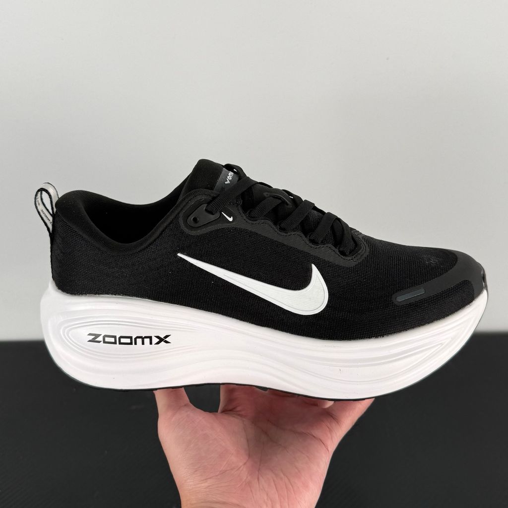 Side profile of the Nike Vomero Plus sneaker in the 'White' colorway, showcasing the clean, monochromatic mesh upper, tonal synthetic overlays, and the sculpted, high-performance foam midsole.
