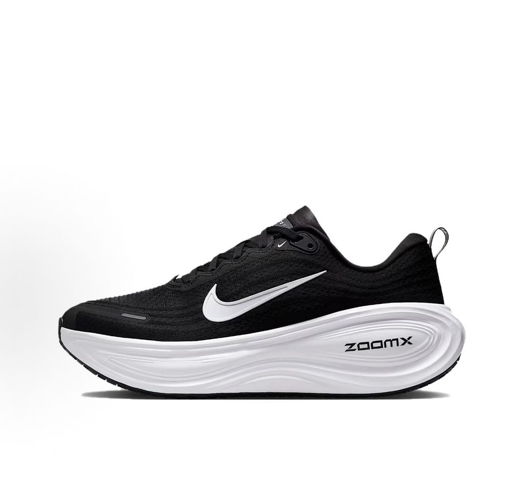 Side profile of the Nike Vomero Plus sneaker in the 'White' colorway, showcasing the clean, monochromatic mesh upper, tonal synthetic overlays, and the sculpted, high-performance foam midsole.