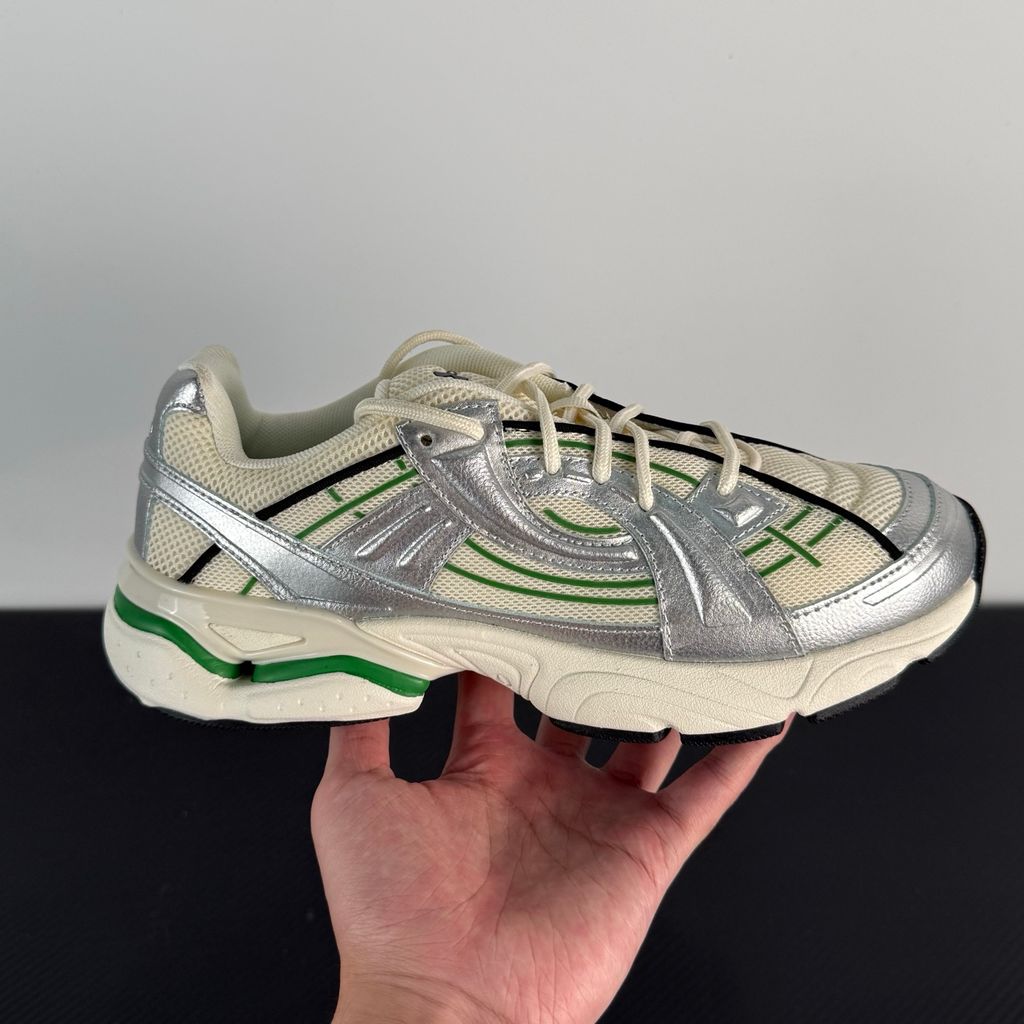Side profile of the Under Armour SolaStone sneaker, highlighting the shimmering metallic silver upper, bold team kelly green branding and midsole accents, and the streamlined, athletic silhouette.