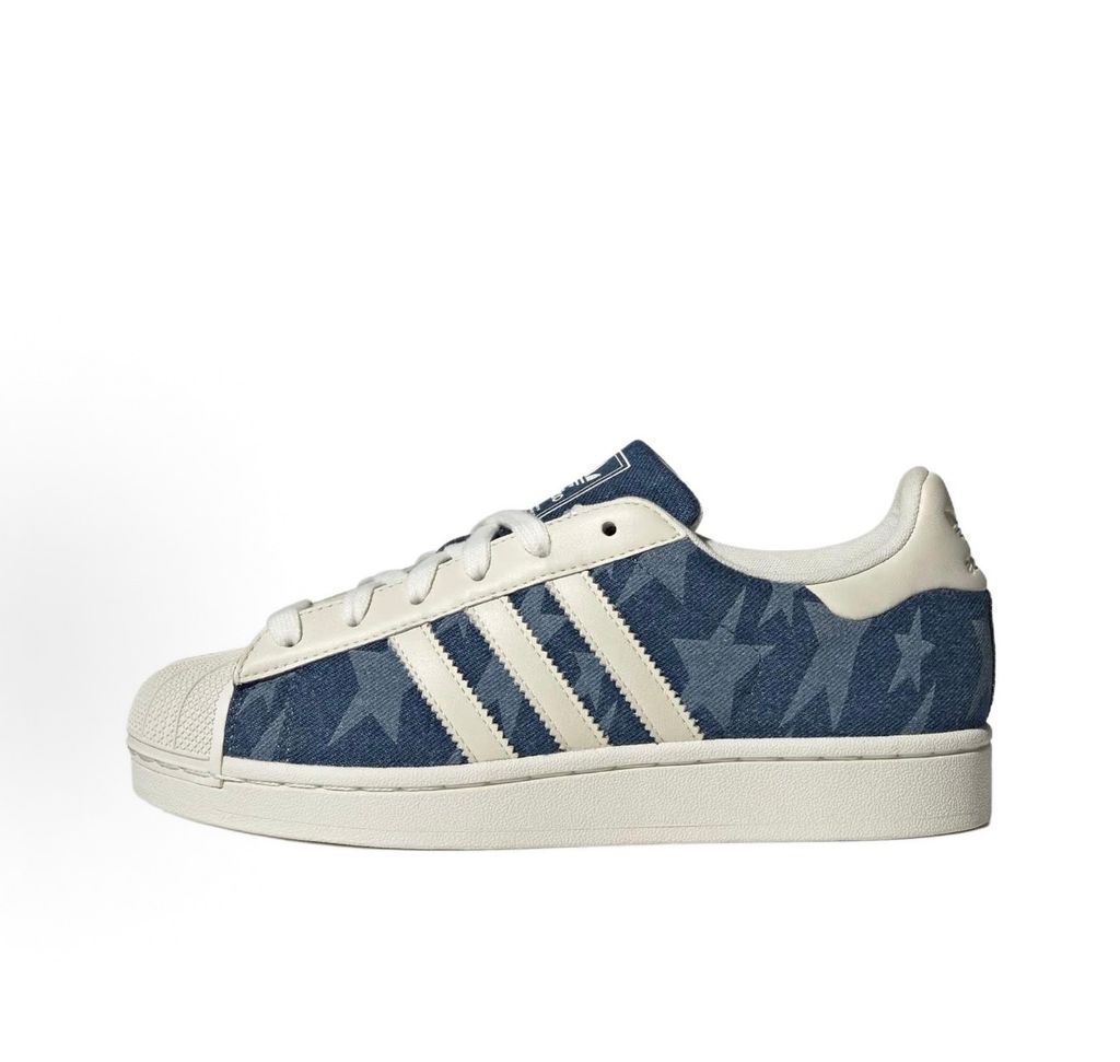 Side profile of the adidas Superstar II 'Denim Star' sneaker, showcasing the textured denim-style upper, classic serrated Three-Stripes branding, and the signature white rubber shell toe.